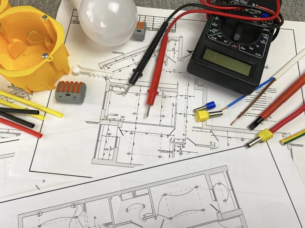 electrician tools on the background of the electrician plan. Place for text. Selective focus.
