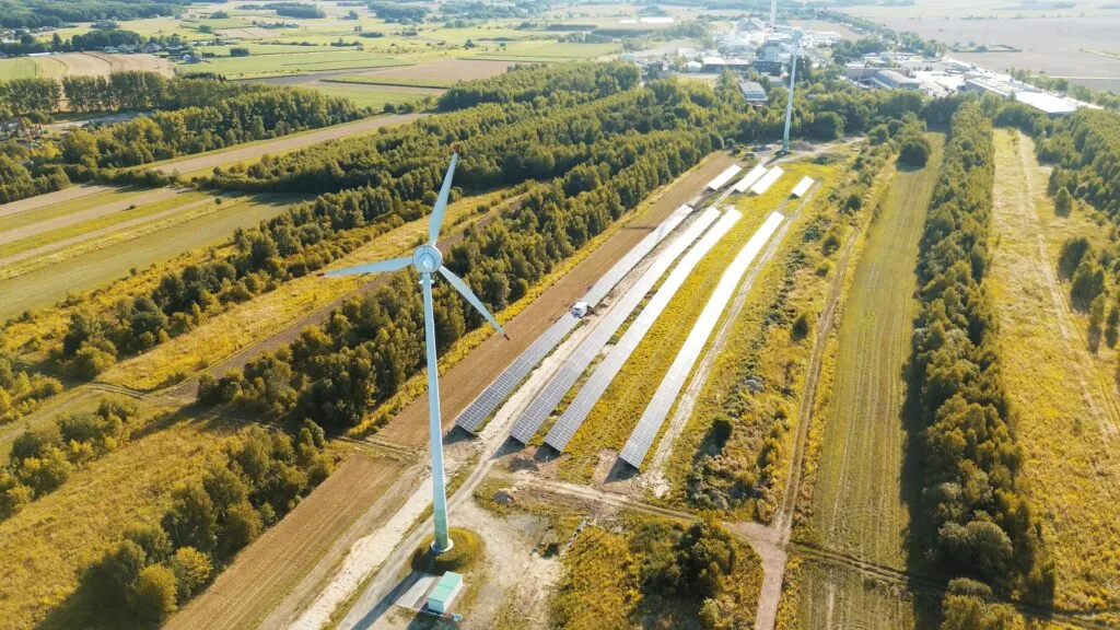 Photovoltaic solar panels with wind turbine and blue sky